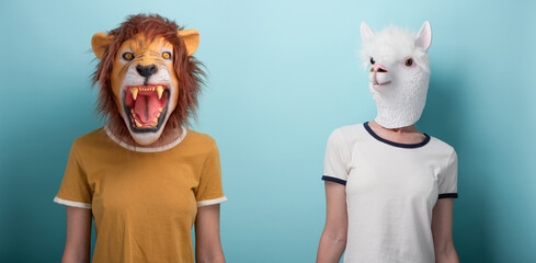 Young woman wearing lion and alpaca mask, standing and looking to the camera, isolated on blue background.