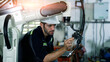 © Chatchawal - Engineer setting up automatic robotics welding arms in factory.