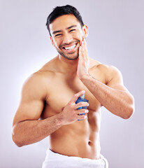 Poster - It cools the irritation. Studio shot of a handsome young man applying aftershave.
