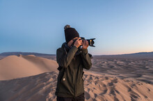 Photographer Shooting On The Great Sand Dunes Of The Gobi Desert