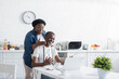 © LIGHTFIELD STUDIOS - happy african american man and woman looking at laptop during video call.