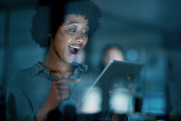 Aufkleber - Do it with passion and anything is possible. Shot of a young businesswoman using a digital tablet and looking surprised during a late night at work.