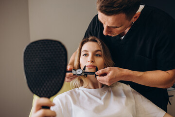 Wall Mural - Young woman having meeting with plastic surgeon