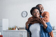 © LIGHTFIELD STUDIOS - happy and senior african american man embracing smiling wife.