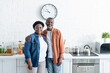 © LIGHTFIELD STUDIOS - happy senior african american couple looking at camera in kitchen.