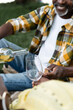 © LIGHTFIELD STUDIOS - cropped view of senior african american man smiling and pouring wine into glass.
