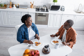 high angle view of happy and senior african american couple having breakfast.