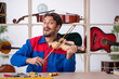 © Elnur - Young man repairing musical instruments at workshop
