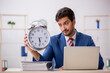 © Elnur - Young male employee in time management concept