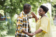 © LIGHTFIELD STUDIOS - happy senior african american couple dancing in park.