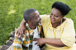 © LIGHTFIELD STUDIOS - high angle view of senior african american couple hugging and smiling in park.