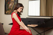 © Dragosh - Beautiful sensual brunette in red dress with wavy hair and glamour makeup and jewelry.