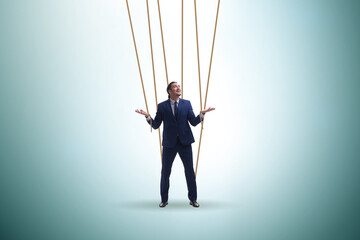 Wall Mural - Businessman puppet being manipulated by ropes