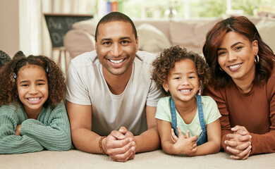 Wall Mural - A house isnt a home without the ones you love. Shot of a young family relaxing at home.