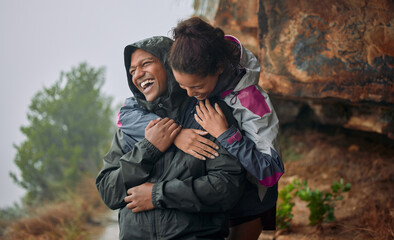 No one could ever make me feel the way you do. Shot of a young couple wearing their rain jackets while out hiking.