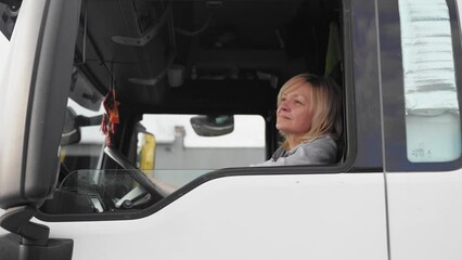 Wall Mural - Caucasian mid age woman driving truck. trucker female worker, transport industry occupation 