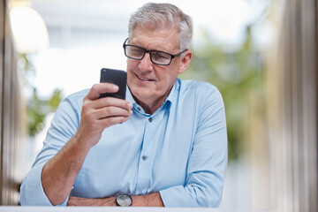 Poster - Checking my schedule from any device. Shot of a mature businessman sitting alone in the office and using his cellphone.