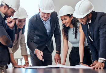 Sticker - This plan needs our expertise. Shot of a group of architects brainstorming in an office.