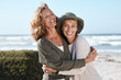 Best friends for life. Cropped shot of two attractive mature women hugging while standing on the beach.