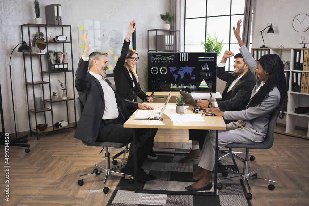Smiling diverse cheerful multiracial businesspeople sit at office desk ...