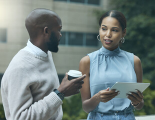 Poster - Keeping their eye on business at every moment. Shot of two businesspeople using a digital tablet together outside an office.