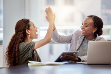 I Couldnt Have Done It Without You. Shot Of Two Young Female Colleagues Giving Each Other A High Five In An Office At Work.