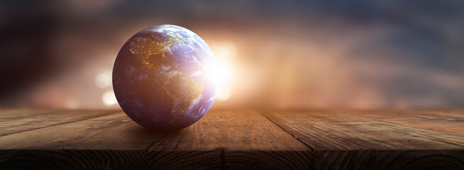 Wall Mural - planet earth on on a wooden table - environmental care concept - Elements of this image furnished by NASA