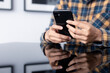 © panitan - using cell phone hand holding mobile texting message contact us.chatting,search internet information in office.technology device communication connecting