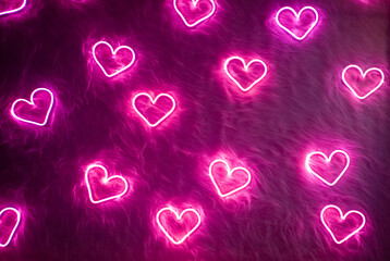 neon pink heart on white fur. valentine's day background