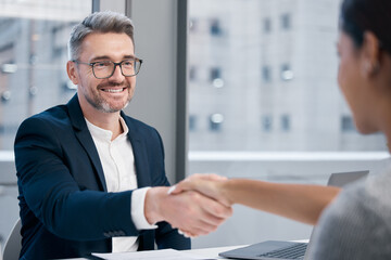 Poster - Youre hired. Shot of two businesspeople shaking hands in an office.