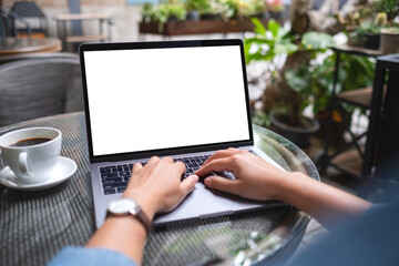 Mockup image of a woman using and working on laptop computer with blank white desktop in the outdoors