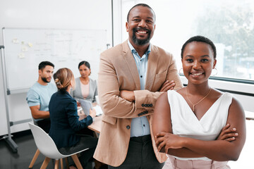 Poster - The team that dreams are made of. Cropped portrait of two businesspeople attending a meeting in the boardroom with their colleagues in the background.