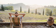 Young man looking at the valley in Tuscany, Italy, relaxation, vacations, lifestyle, summer fun, have a good day, enjoying life concept. Panoramic banner.