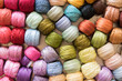 Close up photo of many colorful embroidery thread rolls made of cotton.