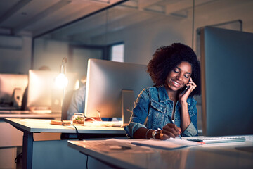 Canvas Print - She wont leave until its all done. Shot of a young businesswoman working late in an office.