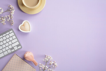 Wall Mural - Flat lay, top view cute office table desk. Feminine workspace with keyboard, coffee cup, notebook, heart shaped candle, bird, flowers on pastel purple background.