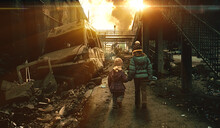 Two Homeless Little Girl Walking In Destroyed City, Soldiers And Helicopters And Tanks Are Still Attacking The City