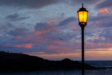 Illuminated Lamp Post By Beach At Sunset, El Cotillo, Fuerteventura, Canary Islands, Spain