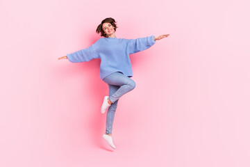 Wall Mural - Full length photo of cheerful pretty person hands flight toothy smile isolated on pink color background