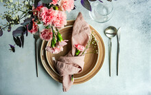 Overhead View Of A Pink Place Setting With Carnations, Gypsophila And Eucalyptus Stems