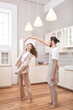 © Наталья Вторушина - Beautiful young couple is dancing and smiling together in kitchen