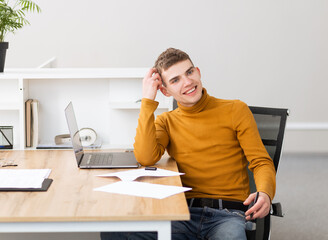 handsome young man working with documents in the office