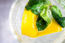 Close-Up Overhead View Of A Glass Of Lemon Water With Mint