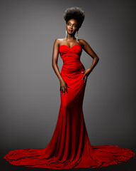 Wall Mural - Fashion Afro American Woman in Red Sexy Dress. African Model with Afro Hair in Long Evening Gown over Gray. Dark Skin Beauty Girl with Golden Earrings and Red Lip happy smiling Full Length Portrait