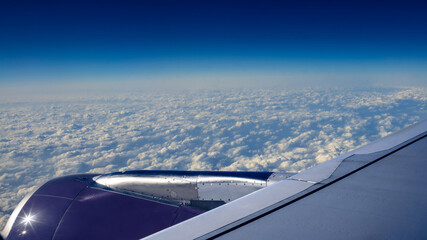 Wall Mural - Traveling by air. Turbine and plane wing in flight trip with beautiful sky.