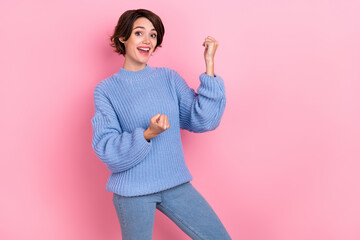 Sticker - Portrait of astonished adorable girl raise fists celebrate triumph isolated on pink color background