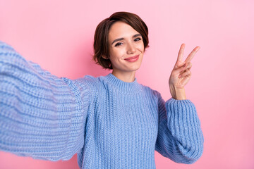 Sticker - Portrait of cute adorable girl take selfie fingers make v-sign isolated on pastel pink color background