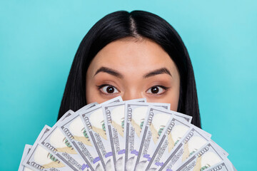 Wall Mural - Close-up photo of charming good mood rich lady cover her face with dollars money isolated on teal color background