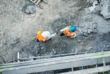 Wall Mural - We dont just built properties, we build relationships. Shot of two builders shaking hands at a construction site.