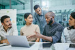 © Siphosethu Fanti/peopleimages.com - I think we have some changes to make. Shot of a group of businesspeople using a laptop during a meeting.